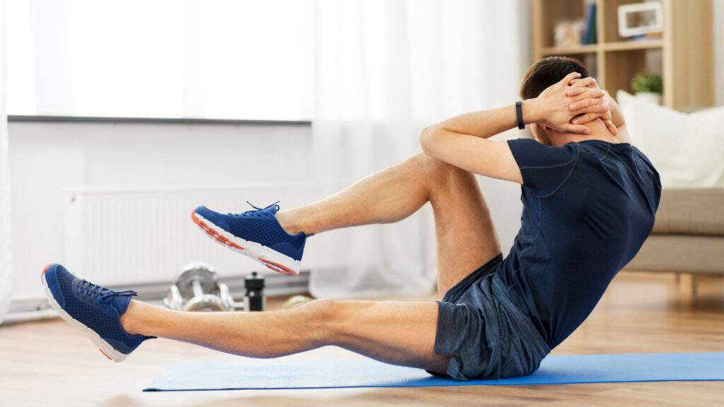 Man performing core exercises on a yoga mat at home: Regular physical activity supports testosterone production, improves blood circulation, and boosts male fertility.