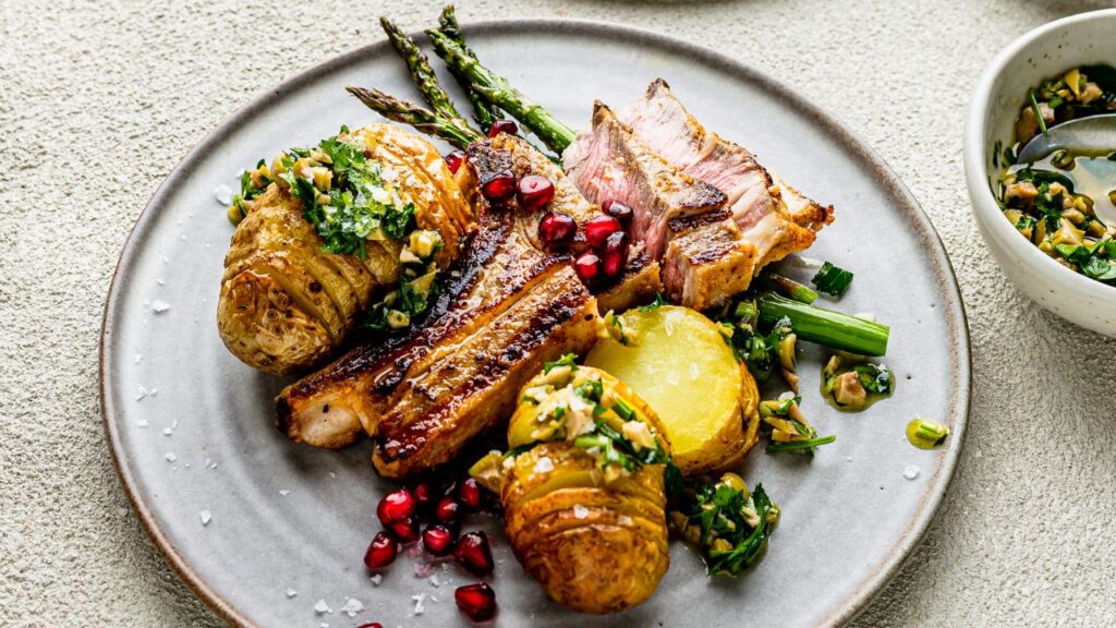 Grilled lamb with roasted potatoes, asparagus, and chimichurri dressing: A fertility-boosting meal rich in L-carnitine for sperm motility and folate for DNA stability.