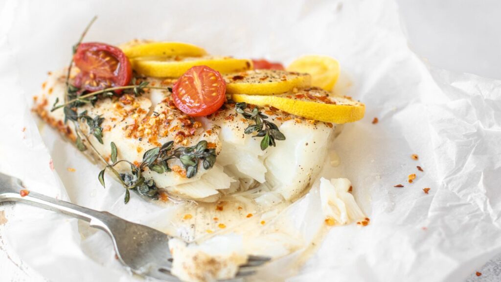 Mediterranean-style baked cod with lemon, cherry tomatoes, and fresh thyme: A top food source of iodine to support thyroid function and sperm production.