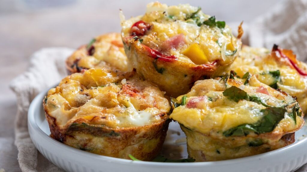 Easy make-ahead high-protein breakfast muffins loaded with eggs, spinach, bell peppers, cheese, and lean protein. These nutrient-dense, fertility-friendly egg muffins are perfect for meal prep, keeping blood sugar balanced and supporting hormone health.